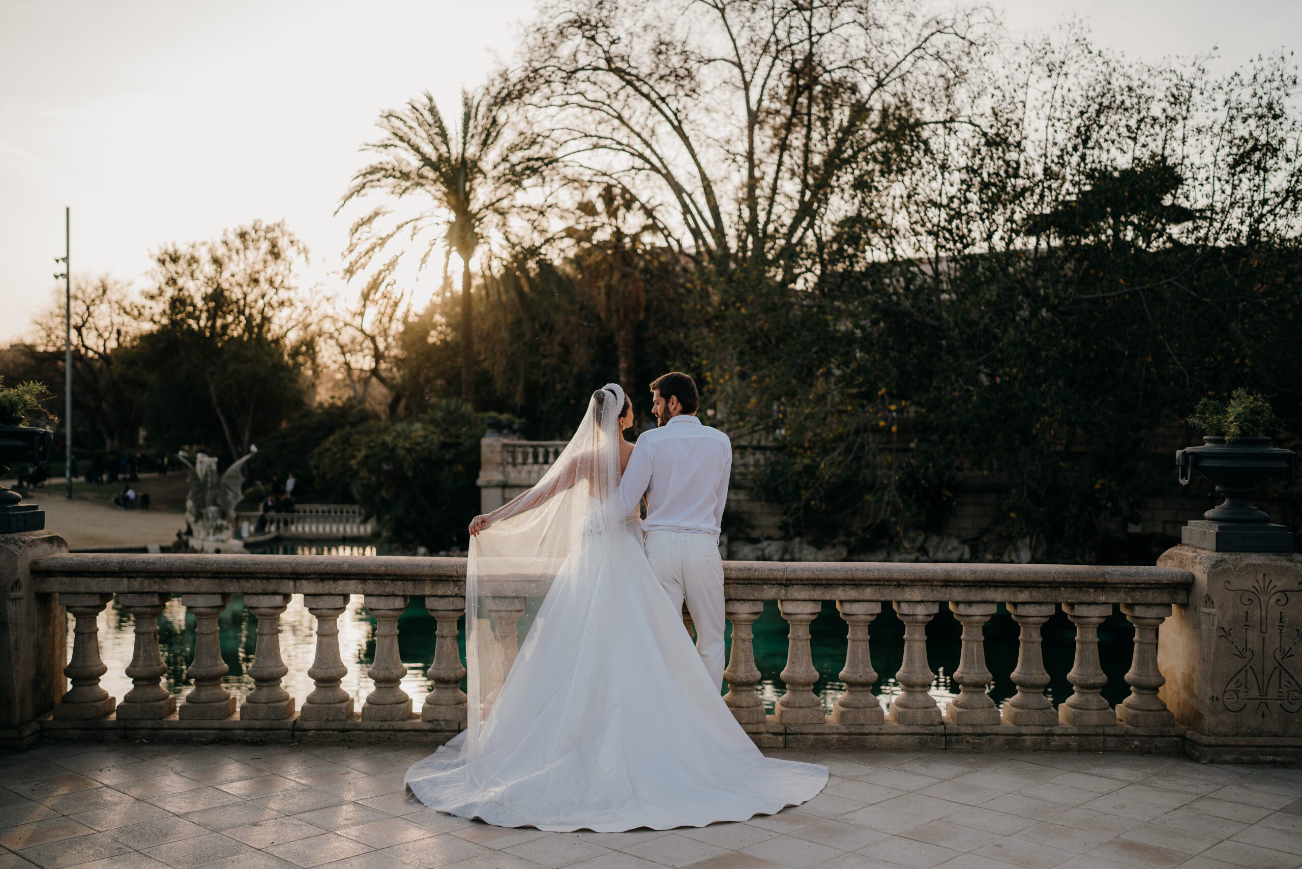 Newly weds at golden hour on the steps of ciutedella park in Barcelona