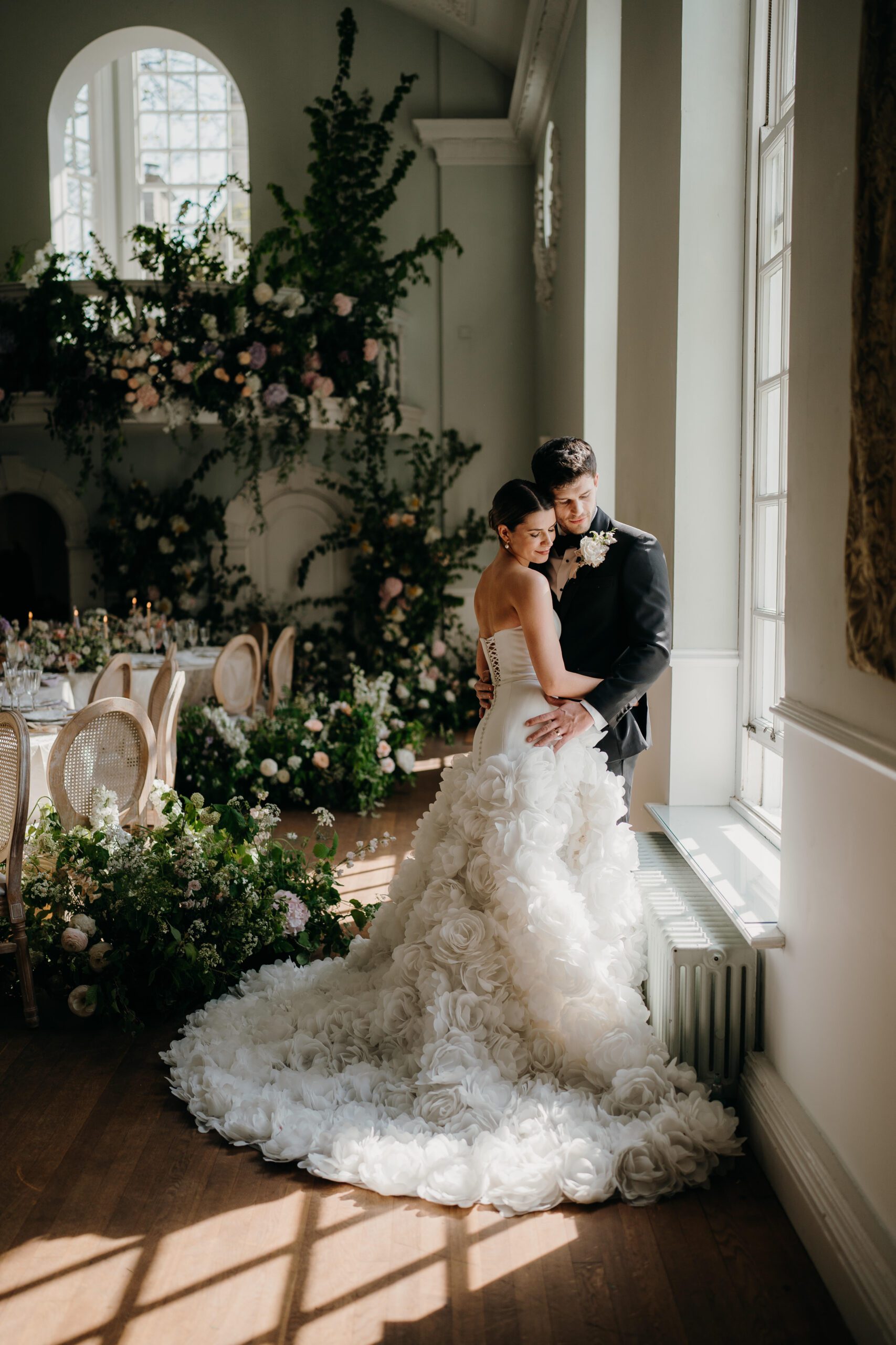 Bride and groom enjoying a playful, romantic moment during their portrait session at Cornwell Manor